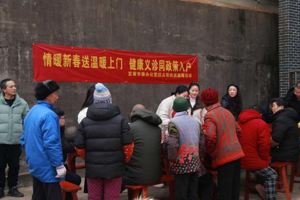 工作人员现场发放春联、宣传政策